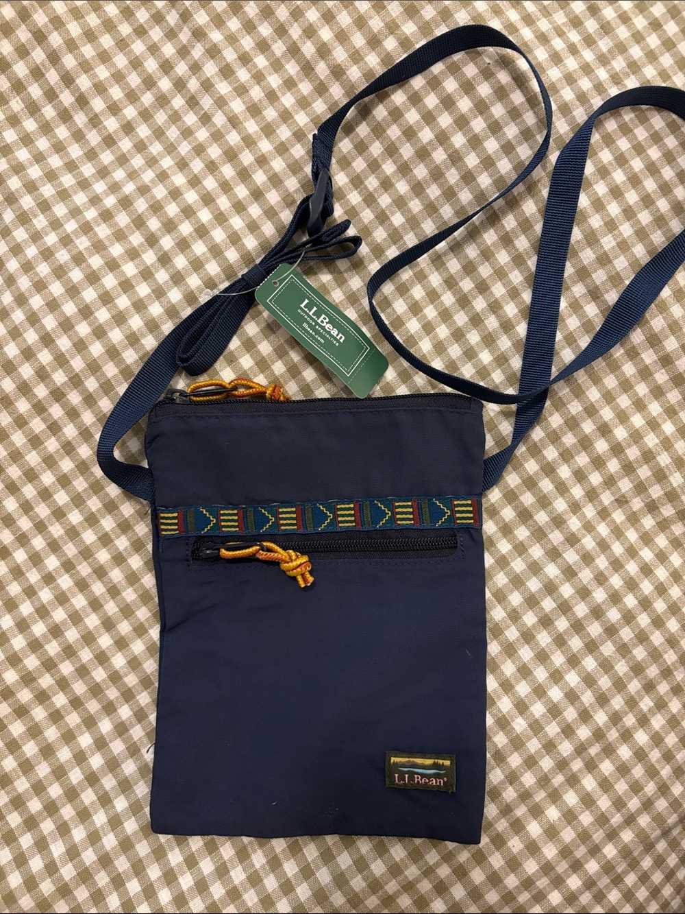 L.L. Bean navy belt bag with multicolor patterned trim and yellow pulls